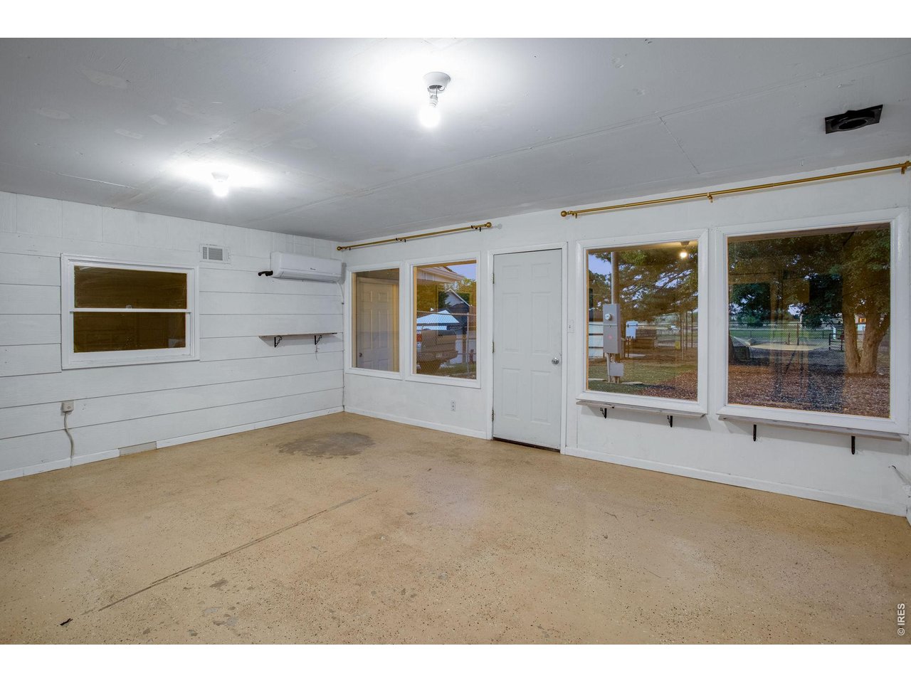 Breezeway between garage and home features front and back patio access and a mini split for cooling. Perfect place for a gym, yoga, party, craft or office 