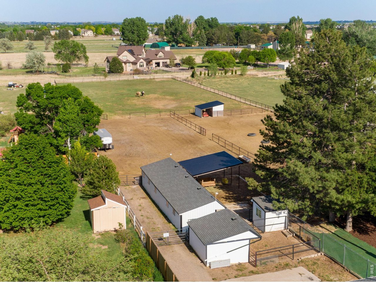 Barn with 2 stalls, chicken coop, loafing shed, hay storage, pasture and a large outdoor riding arena. 