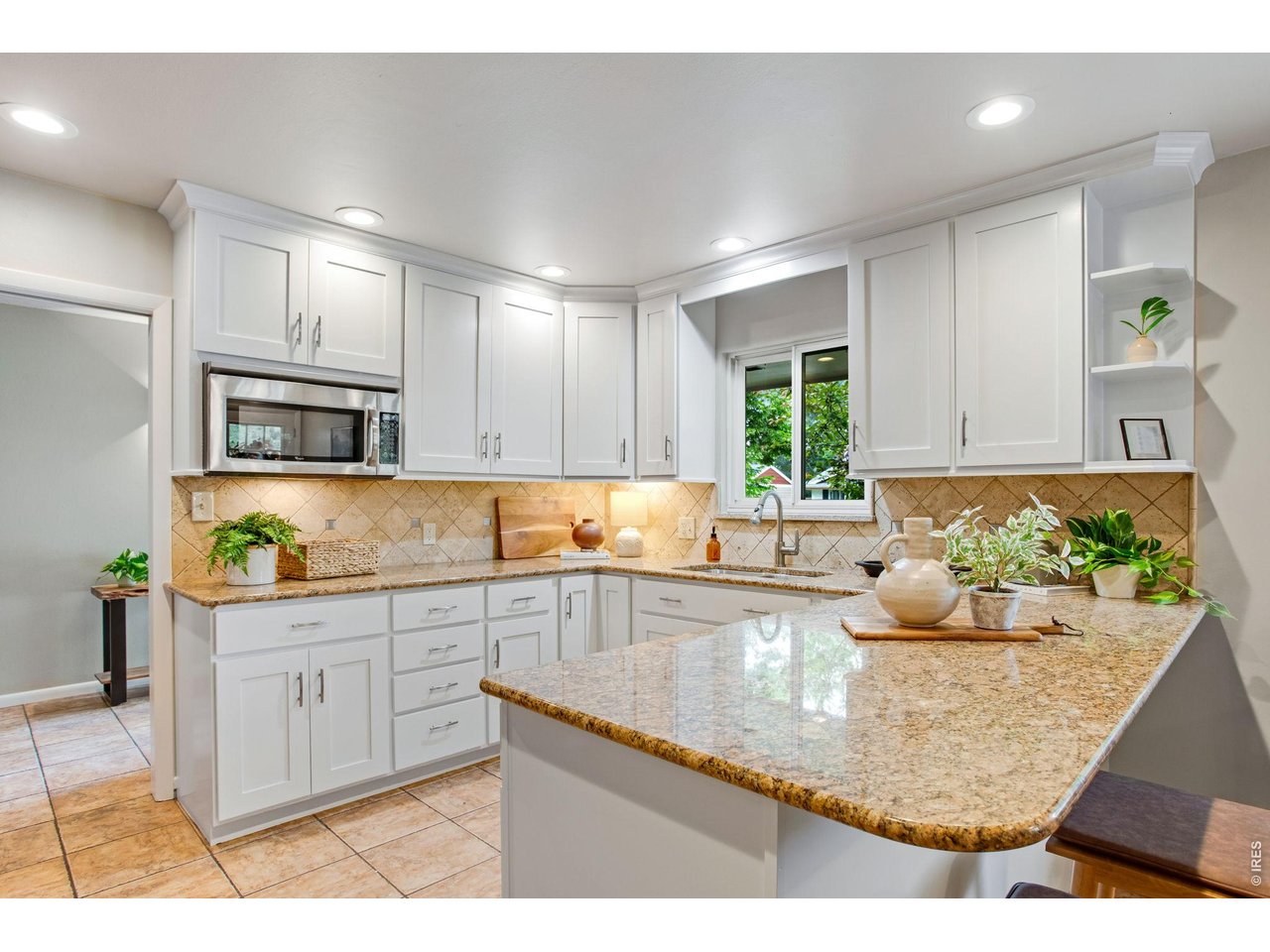 Expansive Chef's kitchen, Freshly painted Shaker cabinetry, Loaded with wonderful workspace, Slab Granite countertops.