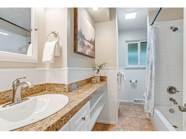 Property Photo 29 Main level full bathroom, granite countertops, tile floors, custom millwork. 