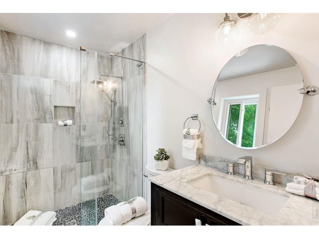 Property Photo 27 Updated Primary Bath with Elegant Tile Design