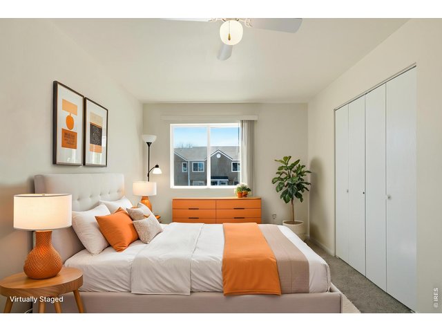 Property Photo 20 Upstairs primary bedroom is bright and spacious. ***Virtually staged with AI***