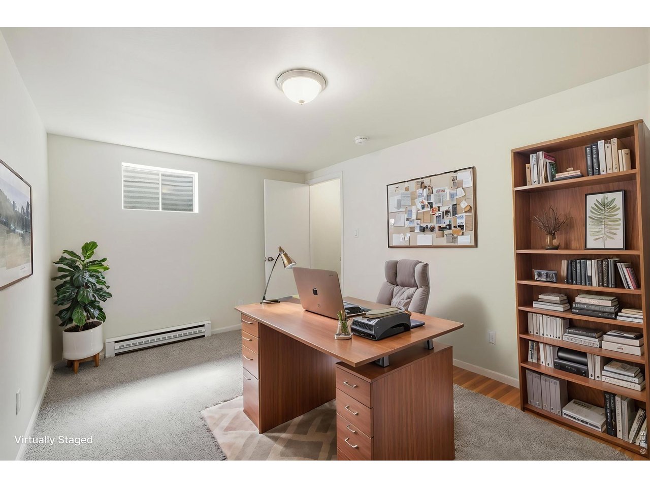 Basement rec room provides a great place to step away from the day to day living area upstairs, or can double as an office. ***Virtually staged with AI***