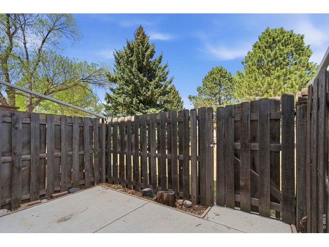 Property Photo 32 Back patio has a freshly poured concrete pad, and opens up to the green space behind that acts as your own huge backyard.