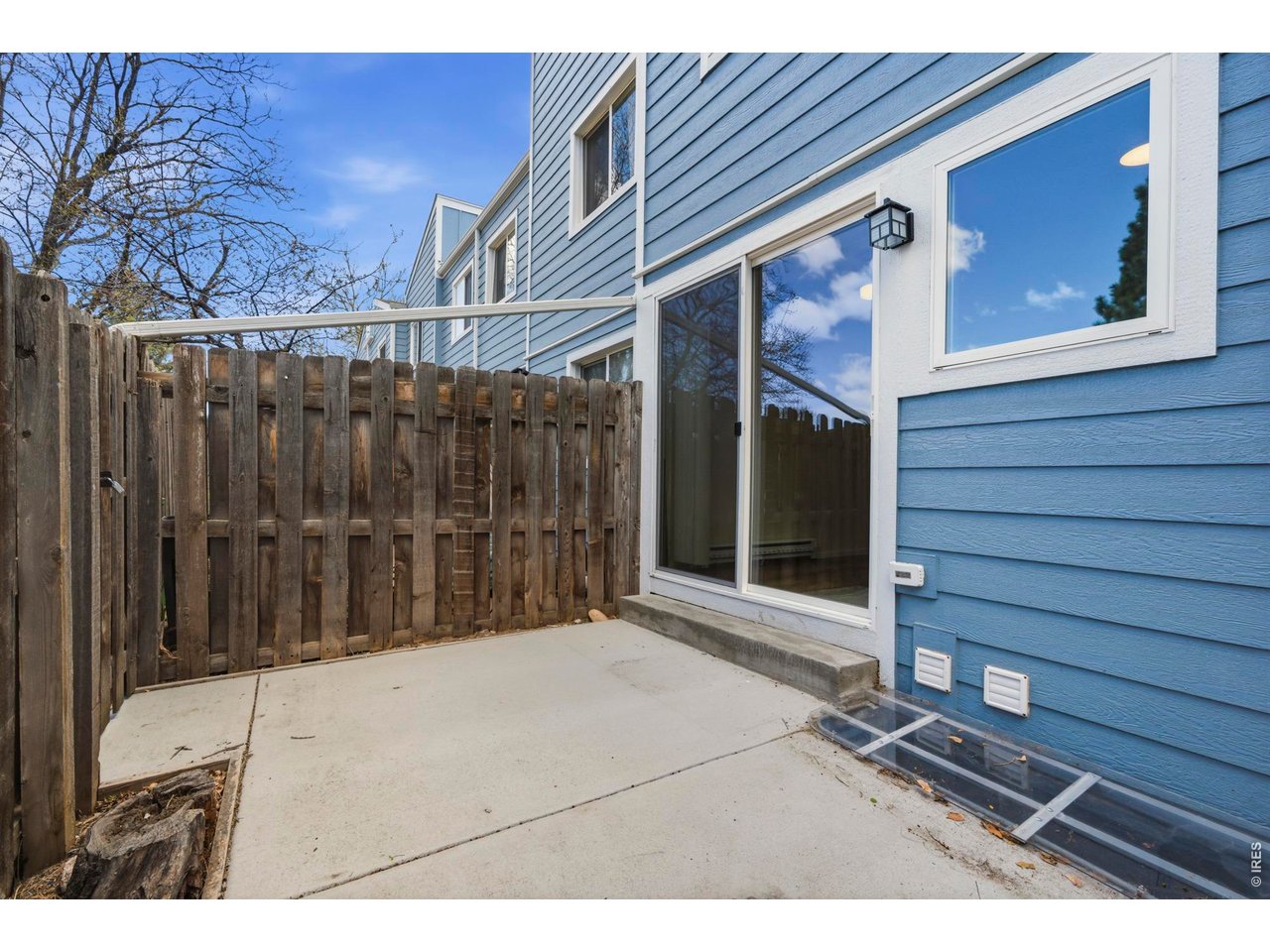Back patio has a freshly poured concrete pad, and opens up to the green space behind that acts as your own huge backyard.