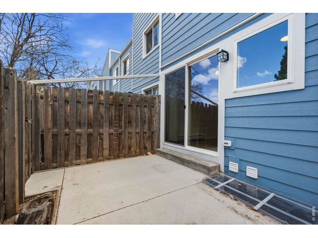 Property Photo 34 Back patio has a freshly poured concrete pad, and opens up to the green space behind that acts as your own huge backyard.