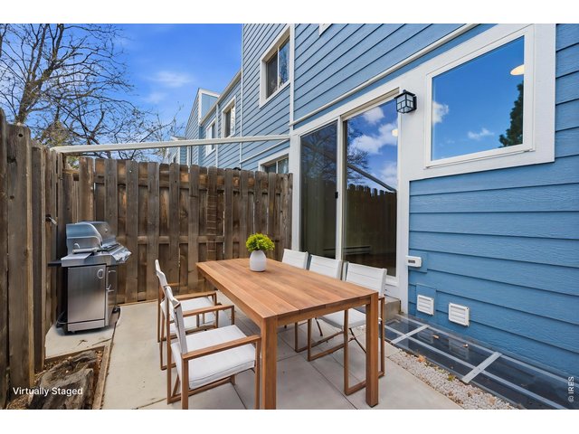 Property Photo 33 Back patio has a freshly poured concrete pad, and opens up to the green space behind that acts as your own huge backyard. ***Virtually staged with AI***