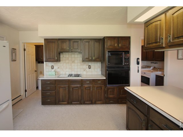 Property Photo 17 Large pantry to the left, laundry room to the right.