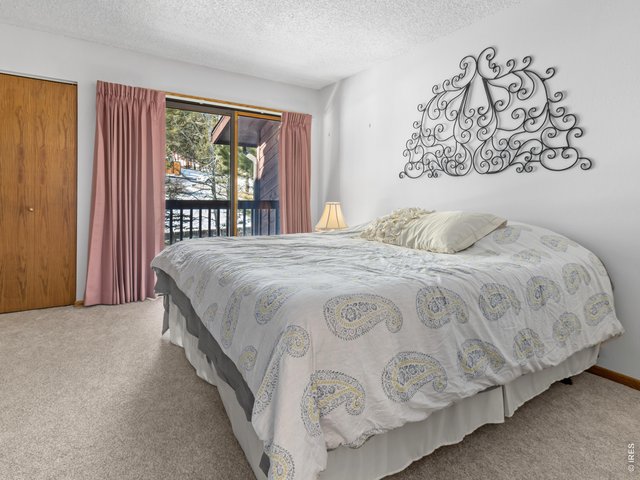 Property Photo 13 Primary bedroom with balcony and ensuite