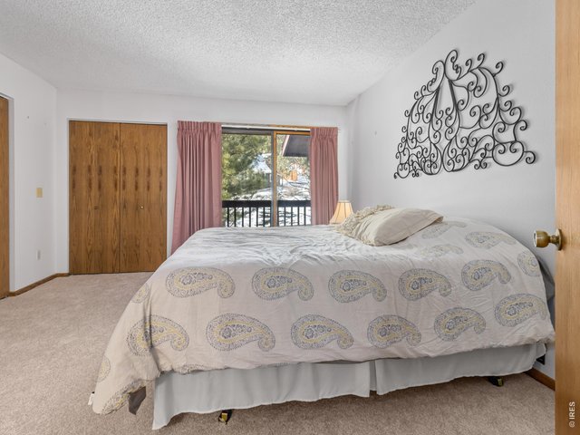 Property Photo 14 Primary bedroom with balcony and ensuite