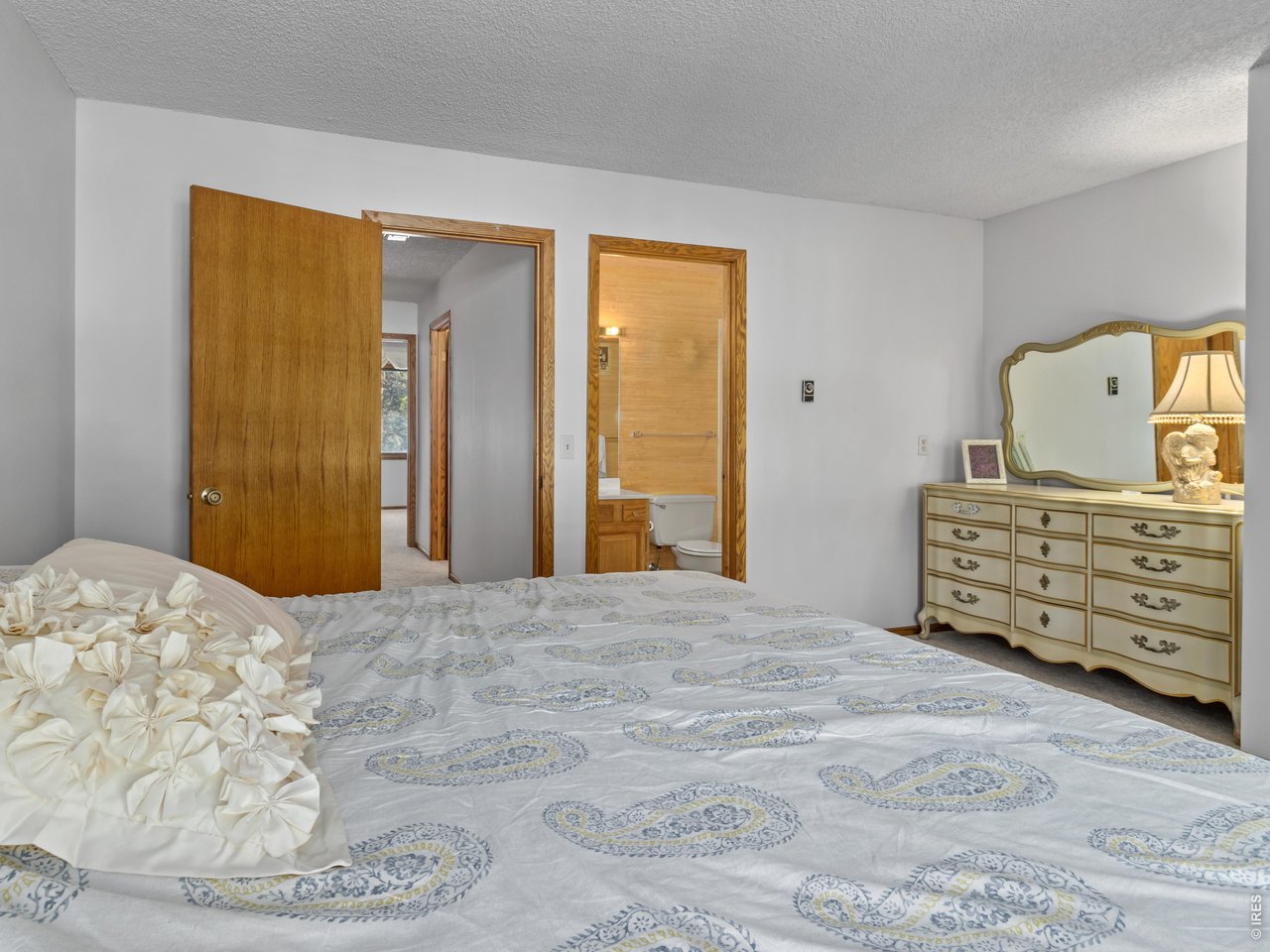 Primary bedroom with balcony and ensuite