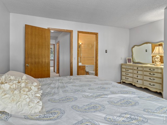 Property Photo 15 Primary bedroom with balcony and ensuite