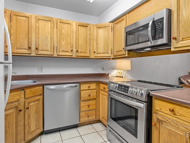 Property Photo 4 kitchen with stainless steel appliances.