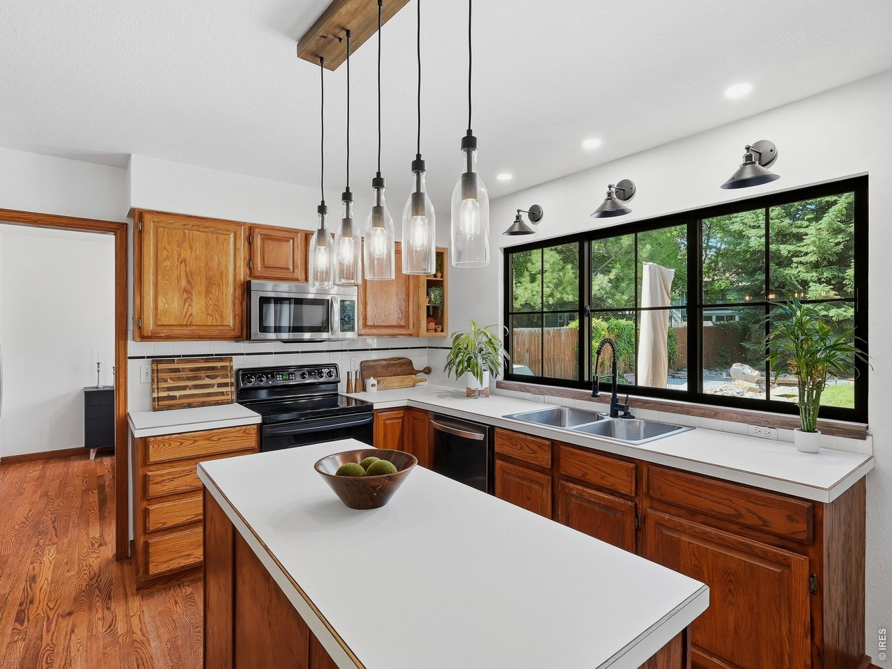 Spacious kitchen overlooking the lush backyard.