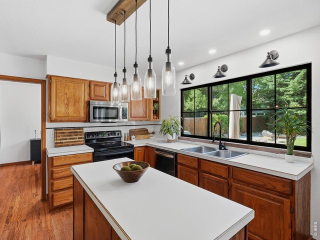 Property Photo 6 Spacious kitchen overlooking the lush backyard.