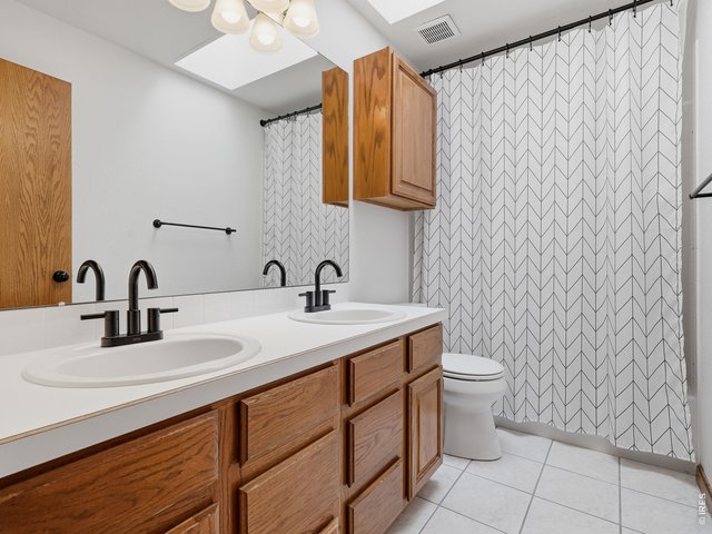 Property Photo 14 Upstairs Bathroom - double sinks, bathtub, shower