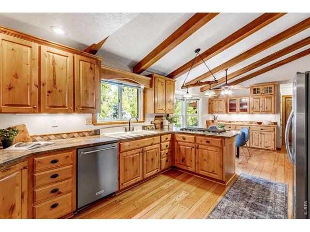 Property Photo 20 The chef's kitchen with beamed vaulted ceilings and hand bolted solid hardwood floors!