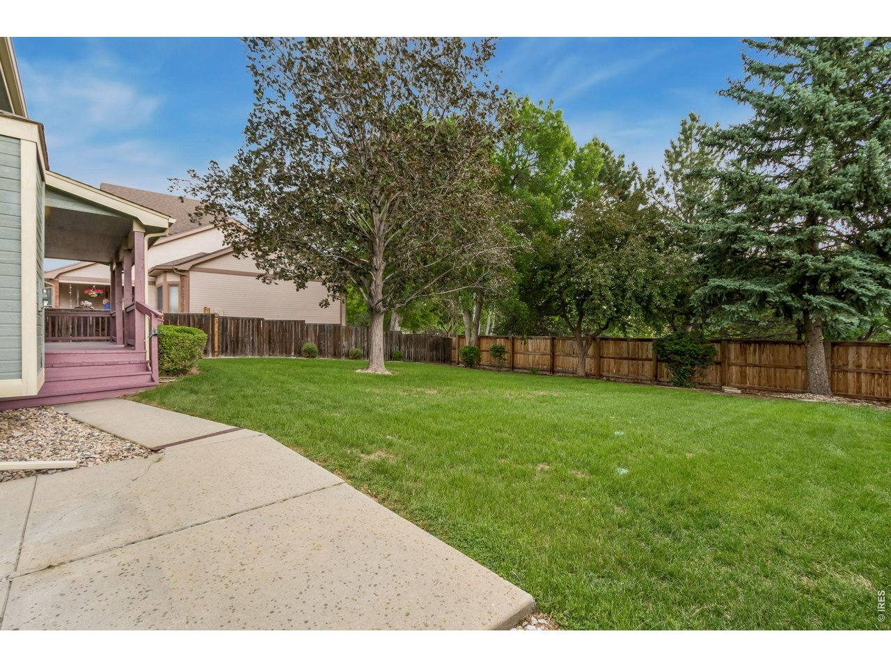 Property Photo 7 Step outside to enjoy the peaceful privacy of the beautifully landscaped backyard, 