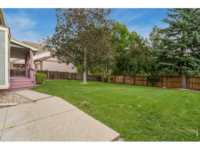 Property Photo 7 Step outside to enjoy the peaceful privacy of the beautifully landscaped backyard, 