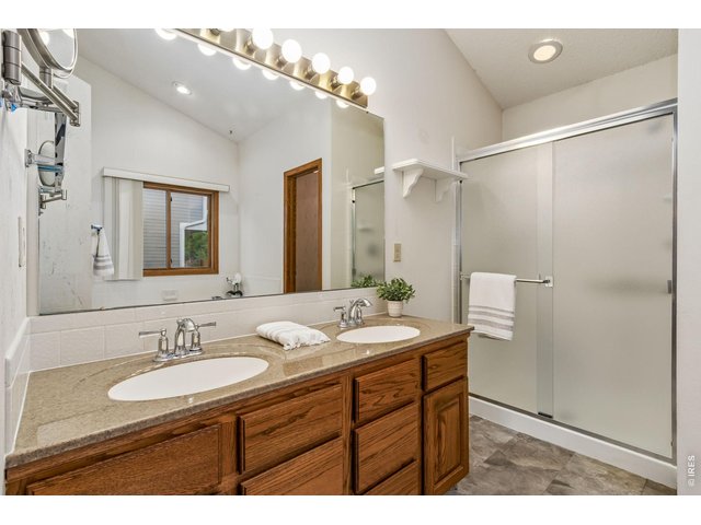 Property Photo 26 five-piece bath featuring dual sinks, a jetted soaking tub, walk-in shower, and linen storage.
