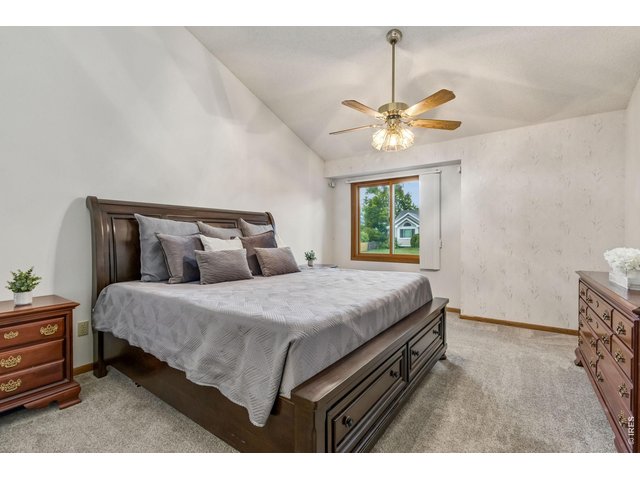 Property Photo 25 Primary suite complete with vaulted ceilings, a spacious walk-in closet, and a luxurious five-piece bath featuring dual sinks, a jetted soaking tub, walk-in shower, and linen storage.