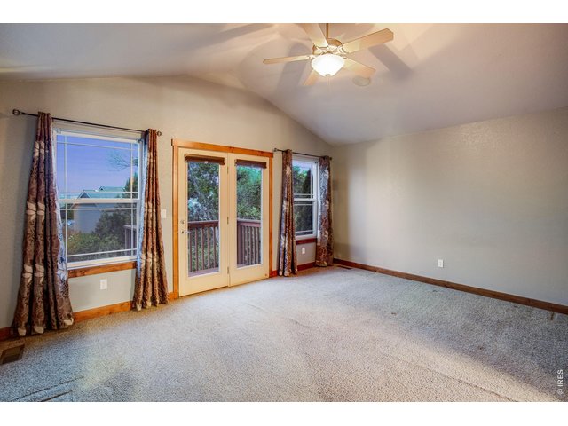 Property Photo 20 Primary bedroom with retreat, private balcony, vaulted ceiling, fan