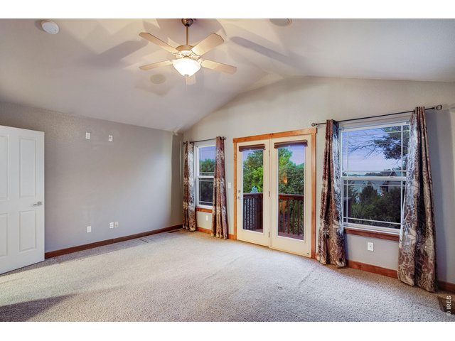 Property Photo 19 Primary bedroom with retreat, private balcony, vaulted ceiling, fan