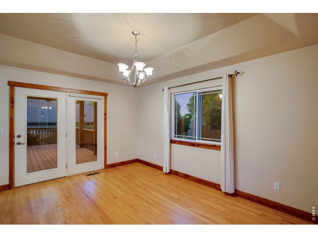 Property Photo 15 Large dining area with tray ceiling and patio access