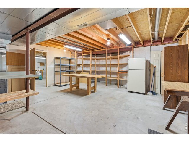 Property Photo 38 This unfinished area in the basement has been uses as a shop and offers a ventilation system and a large utility sink. 
