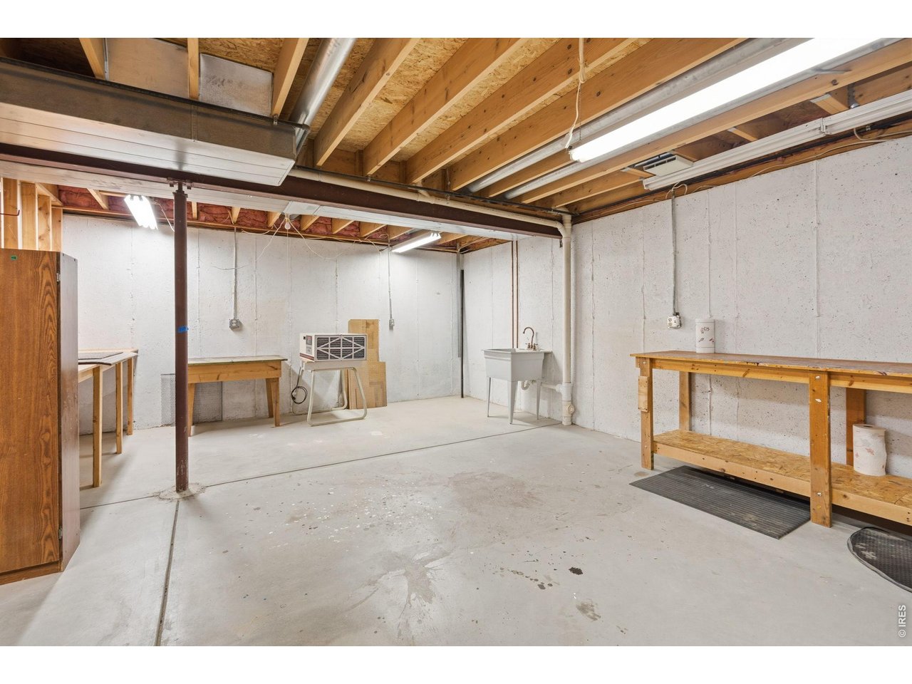 The workbenches and shelving units are included with the sale. 