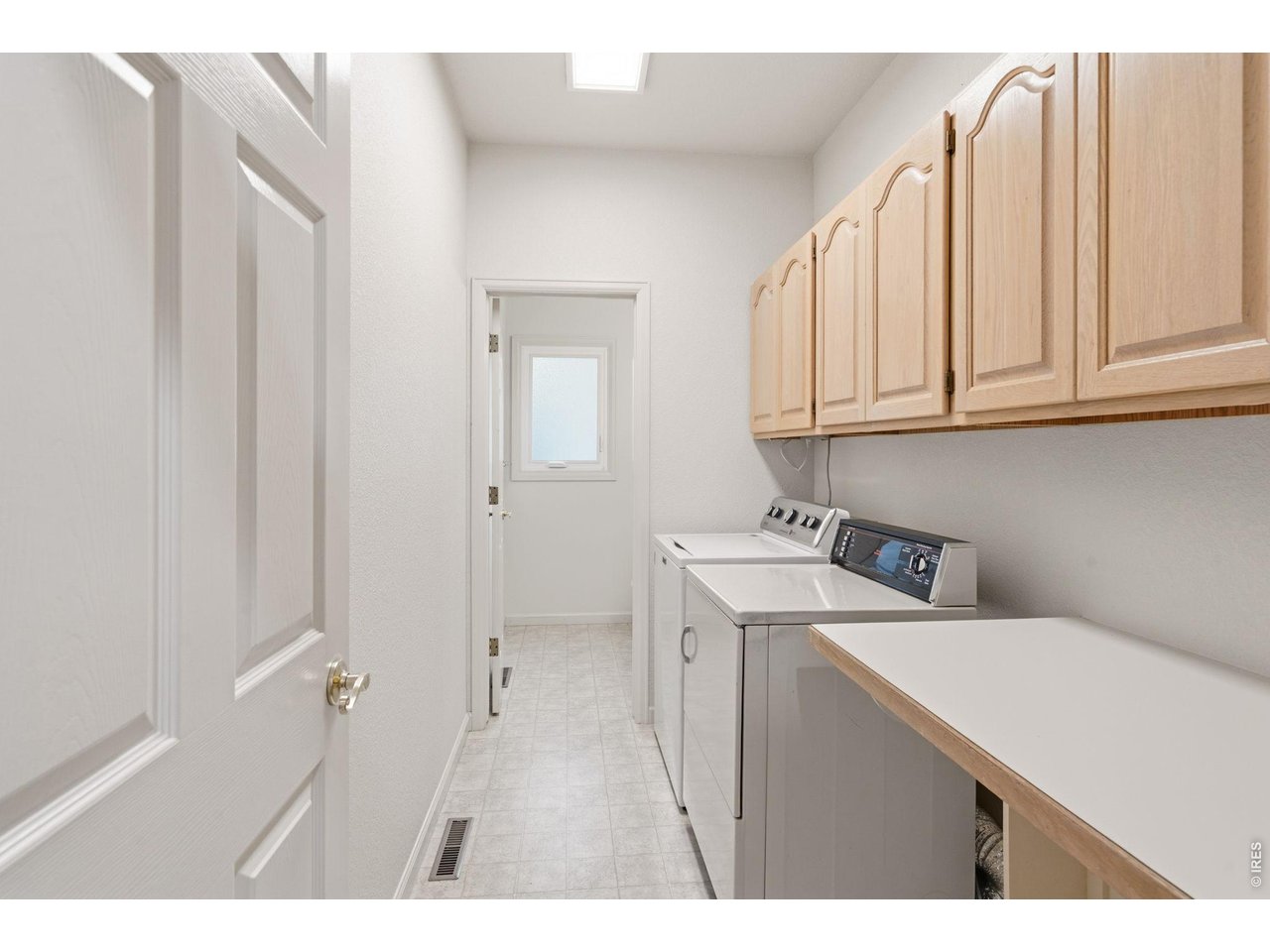 Main level laundry with folding area and a 1/2 bath. 