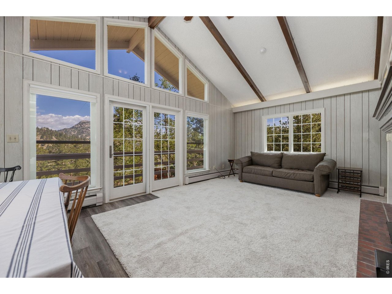 main level living room with vaulted ceiling, new carpet throughout