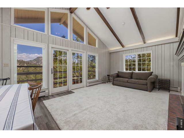 Property Photo 5 main level living room with vaulted ceiling, new carpet throughout