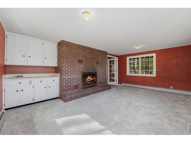 Property Photo 34 wood burning fireplace and wet bar area
