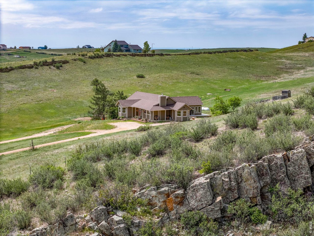 Property Photo 1 Welcome to 5821 W County Road 8E. A glimpse of the home nestled into the surrounding landscape.