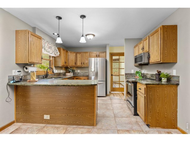 Property Photo 12 The Kitchen - Functional design with ample workspace and storage.