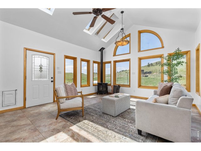 Property Photo 14 Separate sunroom with propane stove creates a comfortable year-round retreat.