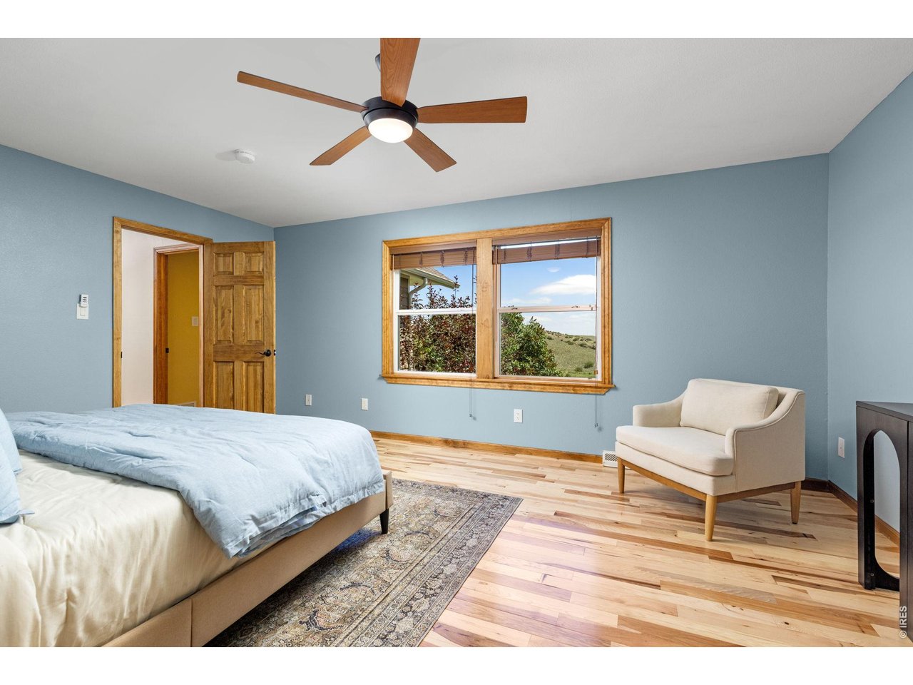 Property Photo 17 The Primary Bedroom - New 3/4-inch hickory hardwood floors continue into this inviting retreat.
