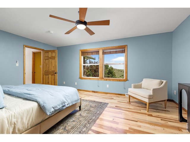 Property Photo 17 The Primary Bedroom - New 3/4-inch hickory hardwood floors continue into this inviting retreat.