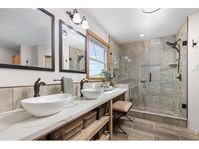 Property Photo 18 The Primary Bathroom - A five-piece layout with a soaking tub and updated finishes.
