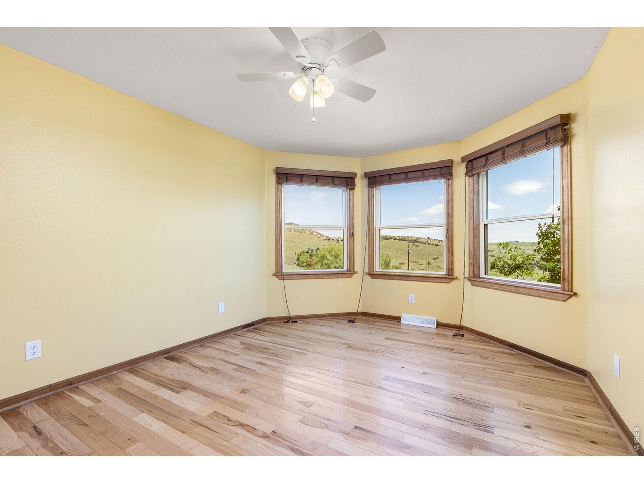 Property Photo 23 Second Upstairs Bedroom - Filled with natural light and continued hardwood flooring.