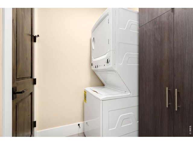 Property Photo 19 Laundry in Unit with additional storage cabinet off secondary bedroom