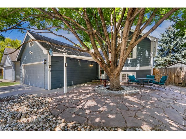 Property Photo 2 A beautiful shade tree and spacious front patio create the perfect spot to relax with your morning coffee or unwind in the evening.
