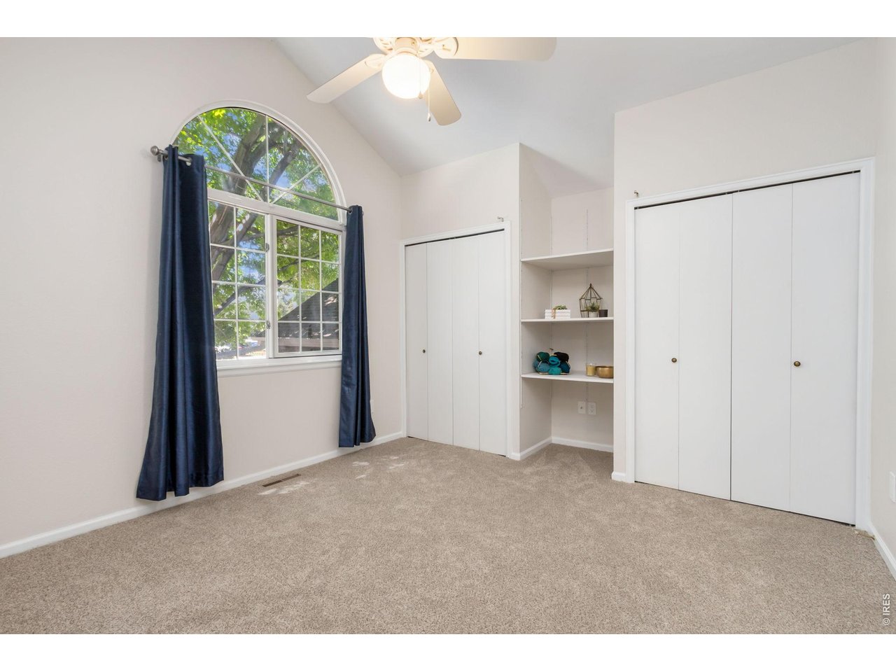 Property Photo 13 Retreat to the spacious primary bedroom featuring vaulted ceilings and plenty of closet space.