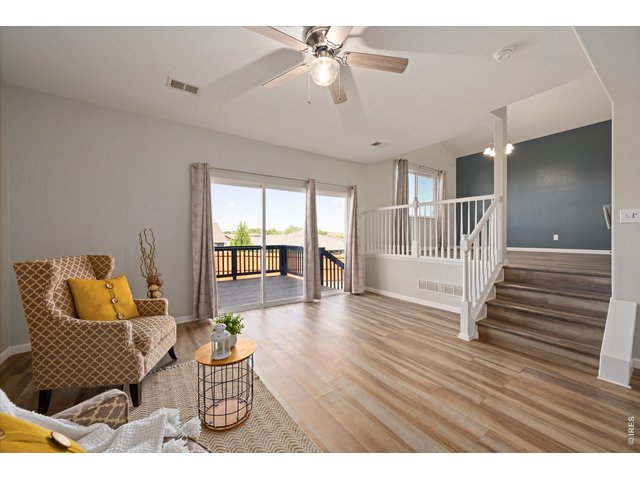 Property Photo 3 Living area with oversized sliding door. This home is flooded with natural light