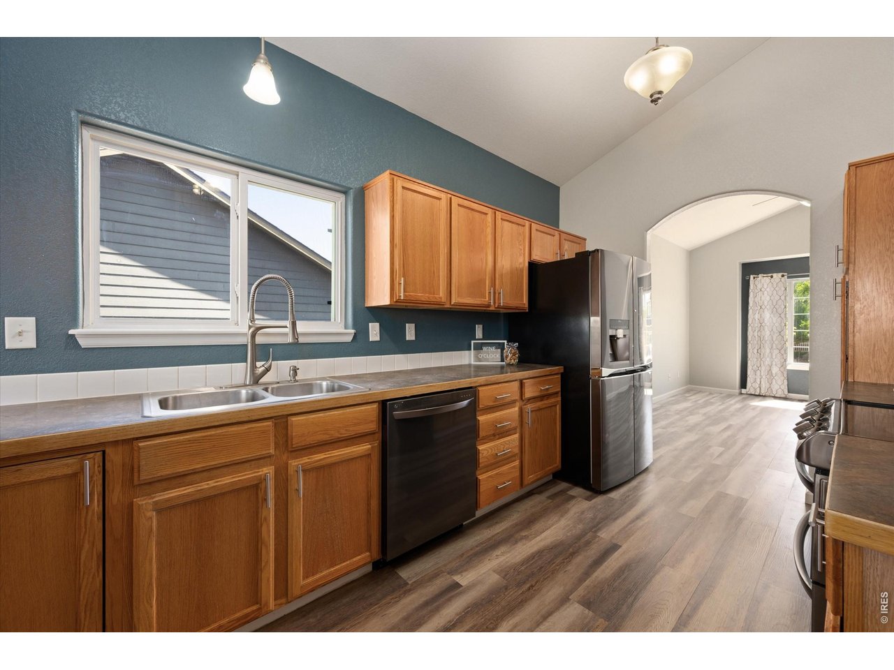 Kitchen with over the sink window and commercial-style pull down faucet,