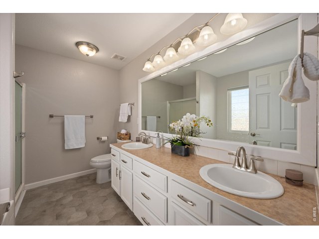 Property Photo 20 Primary bathroom remodeled with tile floor, new faucets/towel bars and cabinet handles