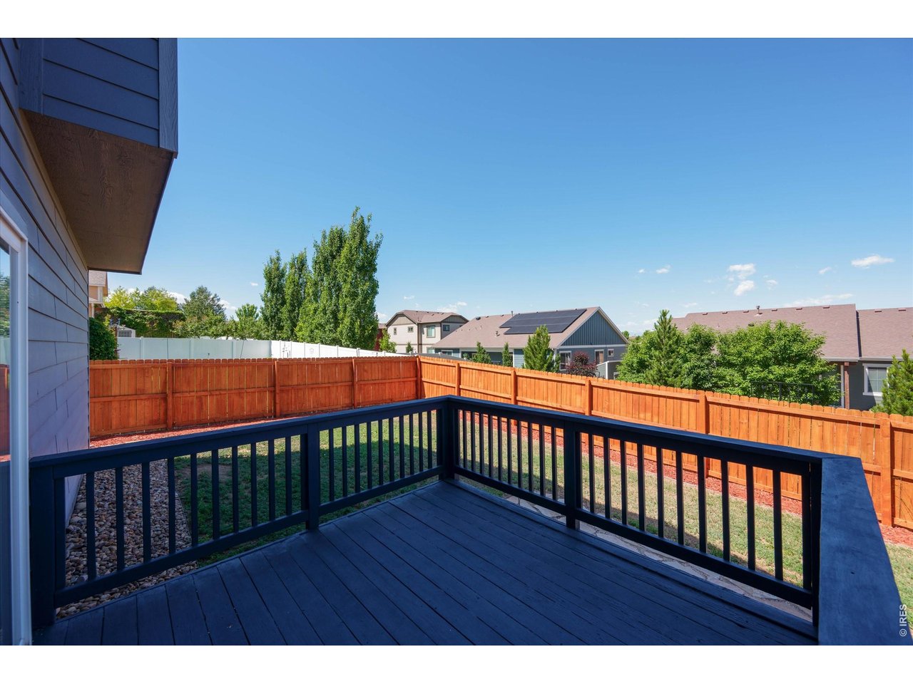 Enclosed Backyard with wood fencing nicely stained