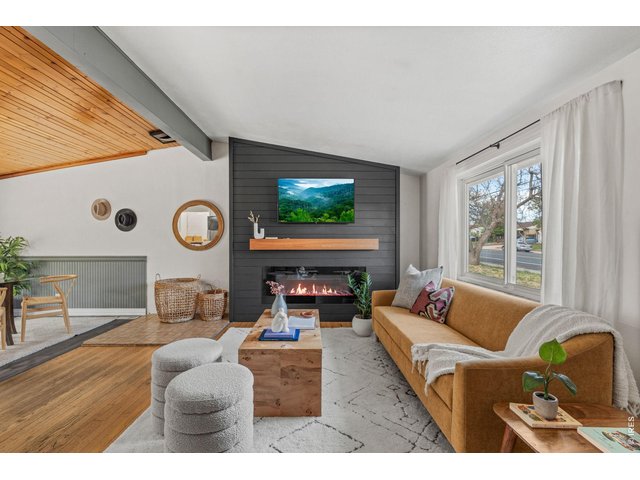 Property Photo 1 Step inside to soaring vaulted ceilings, original hardwood floors, and a stunning wood plank ceiling that flows through the main living space.