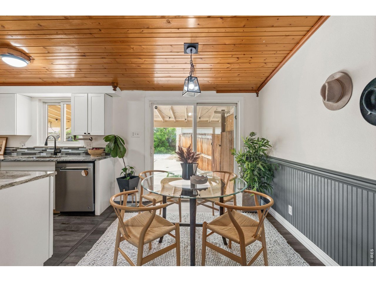 Dedicated dining space with custom wainscoting walks out to the covered back deck.